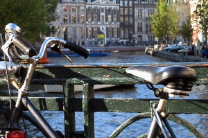 a bike sits on a bridge overlooking the Amsterdam canals